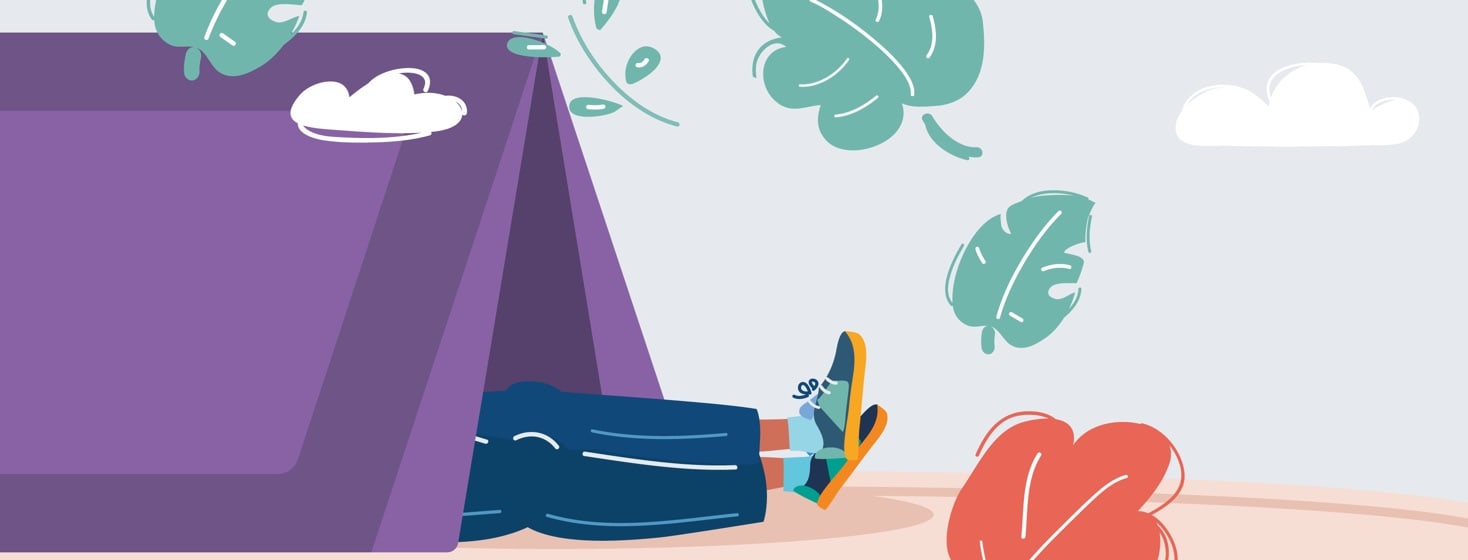 Person reclining on their back in a tent with only their feed sticking out.