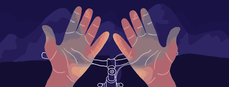 Point of view of a person standing over their bike looking at their hands. The hands are cycling through an array of purples, pinks, and blues.