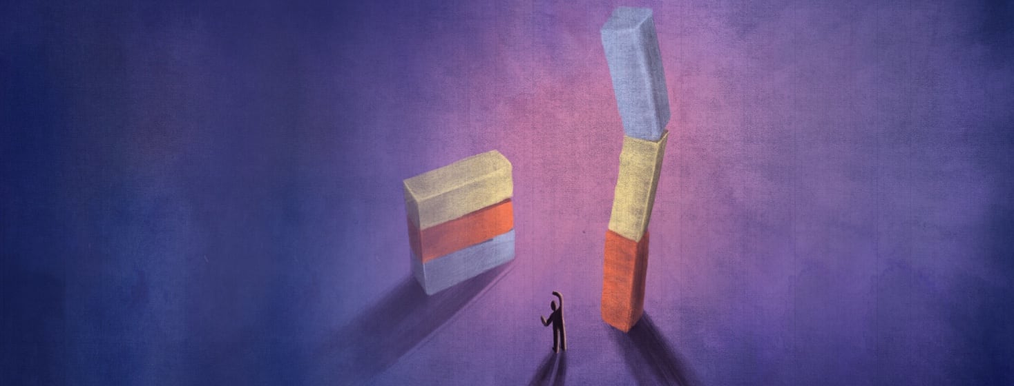 Two stacks of tumbling blocks stand are surrounding a worrying figure.